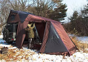 iKamper Skycamp roof top tent is shown deployed on top of a Jeep Rubicon which is mostly obscured by the attached iKamper Annex Room tent.